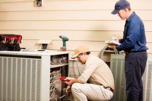 two-technicians-conducting-an-air-conditioning-tune-up