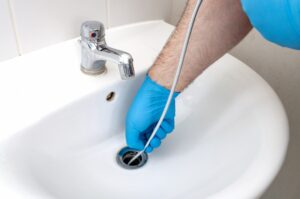 plumber-snaking-bathroom-sink-drain