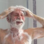 image of a mantaking a shower with soft water.